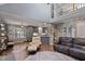 Open-concept living room boasts a vaulted ceiling, hardwood floors, and ample natural light from the large windows at 2302 Fordcrest Dr, Apex, NC 27502