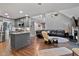 Open floor plan connects kitchen to the vaulted living room with fireplace, and features hardwood floors at 2302 Fordcrest Dr, Apex, NC 27502
