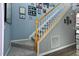 Bright stairway with carpeted stairs and wood trim leading to the upper level with Gathering photos at 2302 Fordcrest Dr, Apex, NC 27502