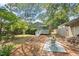 Cozy backyard patio with brick pavers, an outdoor seating area, and lush greenery surrounding the charming home at 2322 Stroller Ave, Durham, NC 27705
