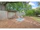 Charming backyard patio with wood storage and a quaint outdoor seating area surrounded by lush greenery at 2322 Stroller Ave, Durham, NC 27705