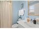 Bathroom featuring light blue walls, a shower, and a classic vanity at 2322 Stroller Ave, Durham, NC 27705