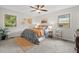 Bright bedroom featuring a ceiling fan, carpet flooring, and two windows for natural light at 2322 Stroller Ave, Durham, NC 27705