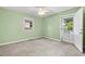 Spacious bedroom featuring green walls and a door leading to the backyard at 2322 Stroller Ave, Durham, NC 27705