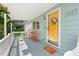 Cozy covered front porch with a seating area and bright yellow door at 2322 Stroller Ave, Durham, NC 27705