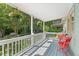 Inviting covered front porch with a seating area and hanging plants at 2322 Stroller Ave, Durham, NC 27705