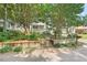 Beautifully landscaped front yard with mature trees, retaining walls, and a charming porch, creating inviting curb appeal at 2322 Stroller Ave, Durham, NC 27705