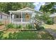 Charming home featuring a covered front porch and beautiful landscaping at 2322 Stroller Ave, Durham, NC 27705