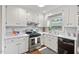 Beautiful kitchen with white cabinets and stainless steel appliances at 2322 Stroller Ave, Durham, NC 27705