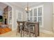 Cozy breakfast nook with rustic table, tile flooring, and a window view to exterior at 240 Oak Grove Church Rd, Youngsville, NC 27596