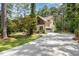 Home exterior featuring a long driveway, two-car garage, and beautifully landscaped yard at 240 Oak Grove Church Rd, Youngsville, NC 27596