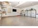 Spacious garage with ample storage cabinets and epoxy flooring at 240 Oak Grove Church Rd, Youngsville, NC 27596
