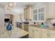 Gourmet kitchen featuring custom cabinets, granite counters, stainless steel appliances, and stylish pendants at 240 Oak Grove Church Rd, Youngsville, NC 27596