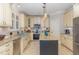 Well-equipped kitchen with an island, stainless steel appliances, custom cabinets, and tile flooring at 240 Oak Grove Church Rd, Youngsville, NC 27596
