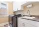 Bright laundry room with modern washer and dryer, plenty of counter space and storage cabinets at 240 Oak Grove Church Rd, Youngsville, NC 27596