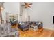 Bright and airy living room with high ceilings, hardwood floors, and large sectional sofa at 240 Oak Grove Church Rd, Youngsville, NC 27596