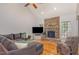 Cozy living room with stone fireplace, vaulted ceiling, hardwood floors, and comfortable seating at 240 Oak Grove Church Rd, Youngsville, NC 27596