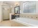 Relaxing main bathroom features a jacuzzi tub, a large mirror, and a glass door shower at 240 Oak Grove Church Rd, Youngsville, NC 27596