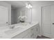 Bright bathroom featuring double sinks, white cabinets, and modern fixtures at 2539 Kasota Ln, Raleigh, NC 27610