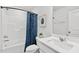 Bright bathroom with shower and tub combination, modern vanity and cabinet offering style and function at 2539 Kasota Ln, Raleigh, NC 27610