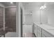 Modern bathroom features a walk-in shower with tile and a double sink vanity at 2539 Kasota Ln, Raleigh, NC 27610