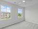 Carpeted bedroom with large windows offering community views at 2539 Kasota Ln, Raleigh, NC 27610