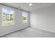 Bright bedroom with large windows offering great light and neutral decor creating a calming space at 2539 Kasota Ln, Raleigh, NC 27610