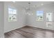 Dining room with modern chandelier and sliding doors letting in natural light at 2539 Kasota Ln, Raleigh, NC 27610