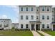 Well-maintained two-story townhouse with neutral siding, manicured landscaping, and welcoming front entries at 2539 Kasota Ln, Raleigh, NC 27610