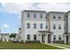 Well-maintained two-story townhouse with neutral siding, manicured landscaping, and welcoming front entries at 2539 Kasota Ln, Raleigh, NC 27610