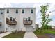 New construction townhome with a two-car garage and small wooden balconies at 2539 Kasota Ln, Raleigh, NC 27610