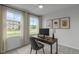 Bright home office featuring a modern desk setup, large windows, and neutral decor creating a productive workspace at 2539 Kasota Ln, Raleigh, NC 27610