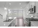 Bright, open kitchen with stainless steel appliances, white cabinets, and an island at 2539 Kasota Ln, Raleigh, NC 27610