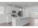 Modern kitchen with stainless steel appliances, white cabinets, and a center island with seating and ample countertop space at 2539 Kasota Ln, Raleigh, NC 27610