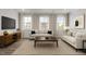 Inviting living room with large windows, comfortable seating, and stylish decor at 2539 Kasota Ln, Raleigh, NC 27610