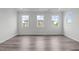 Bright, empty room with wood flooring and three large windows at 2539 Kasota Ln, Raleigh, NC 27610