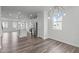 Open floorplan showcasing the kitchen with white cabinets and stainless steel appliances at 2539 Kasota Ln, Raleigh, NC 27610