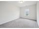 Neutral colored bedroom with a carpet floor, a window, and neutral colored walls at 2613 Red Spruce Dr, Raleigh, NC 27616