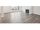 Elegant living room highlighting sleek hardwood floors, a classic fireplace, and abundant natural light at 2613 Red Spruce Dr, Raleigh, NC 27616