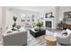 Cozy living room featuring a fireplace, large windows, and modern furnishings, creating an inviting atmosphere at 2613 Red Spruce Dr, Raleigh, NC 27616
