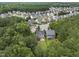 An aerial view of the home surrounded by lush greenery with houses nearby in a suburban neighborhood at 2904 Britmass Dr, Raleigh, NC 27616