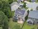 Aerial view of the backyard of a home, with solar panels, patio, and fenced yard at 2904 Britmass Dr, Raleigh, NC 27616