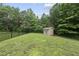 Fenced backyard with storage shed backing up to a beautiful green space at 2904 Britmass Dr, Raleigh, NC 27616