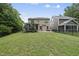 Home's fenced backyard features an established lawn and patio at 2904 Britmass Dr, Raleigh, NC 27616