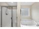 Bathroom featuring an enclosed shower and a soaking tub with a privacy window at 2904 Britmass Dr, Raleigh, NC 27616