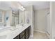 Bright bathroom with double vanity, walk-in shower, and a separate bathtub at 2904 Britmass Dr, Raleigh, NC 27616