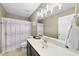Functional bathroom with a vanity, large mirror, and a shower with a patterned curtain at 2904 Britmass Dr, Raleigh, NC 27616