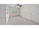 Bright bedroom with built-in bookshelves, carpeted floors, and a ceiling fan at 2904 Britmass Dr, Raleigh, NC 27616
