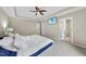 Spacious main bedroom with plush carpet, tray ceiling, ceiling fan, TV and a view into the bathroom at 2904 Britmass Dr, Raleigh, NC 27616