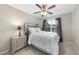Cozy bedroom with a bed, nightstand, and a window with dark curtains at 2904 Britmass Dr, Raleigh, NC 27616